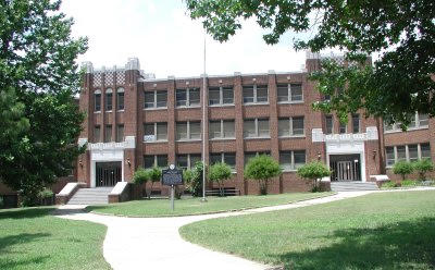 The front of the Dunbar building today, three stories of brick with a historical marker on the lawn
