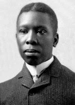 Portrait of Paul Laurence Dunbar as a young man in a dark suit and high collar